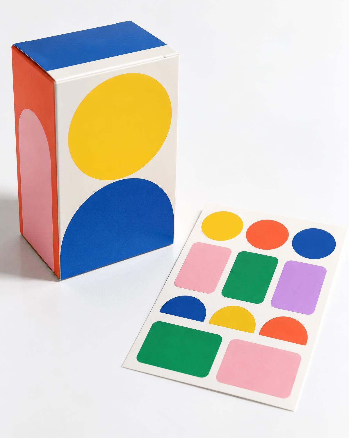 Printed folding carton beside colourful adhesive labels